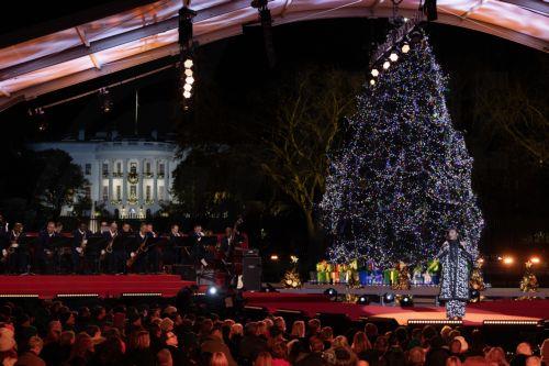 epa11004928 US music artist Samara Joy performs during the lighting of the National Christmas Tree on the Ellipse near the White House, in Washington, DC, USA, 30 November 2023. The lighting of the tree is an annual tradition attended by the US President and the First Family. President Calvin Coolidge lit the first National Christmas tree, a 14.6-meter-high...