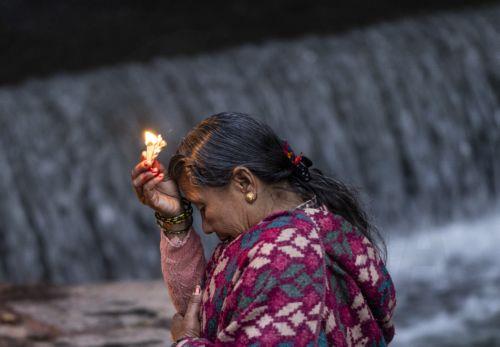 epa11117230 A woman worships after taking a holy bath in the Salinadi River during the Madhav Narayan festival in Sankhu, on the outskirts of Kathmandu, Nepal, 01 February 2024. The Madhav Narayan festival is a full month-long event devoted to religious fasting, holy bathing and the study of the Swasthani book, which is dedicated to the God Shiva and...