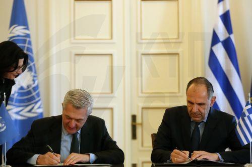 epa11165657 Greek Foreign Minister Giorgos Gerapetritis (R) and Filippo Grandi (2-L), UN High Commissioner for Refugees (UNHCR), attend the signing ceremony for the Seat Agreement between Greece and the UN Refugee Agency, after their meeting in Athens, Greece, 19 February 2024. The Agreement will regulate the operating status of the UNHCR office in Greece. ...
