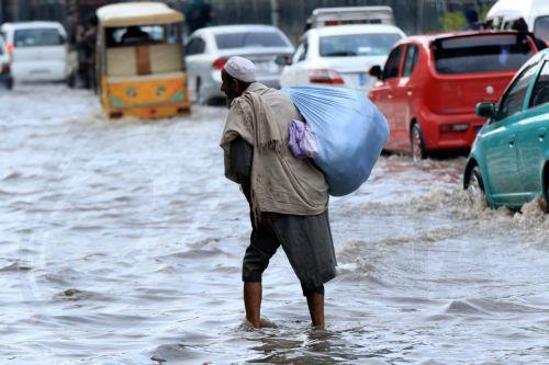 epa11165901 Motorists in a flooded street during a heavy downpour in Peshawar, Pakistan, 19 February 2024. According to the Provincial Disaster Management Authority, at least four people have died and nine have been injured, with numerous buildings damaged as a result of ongoing rains across the province, with more rain expected in the region.  EPA/BILAWAL...