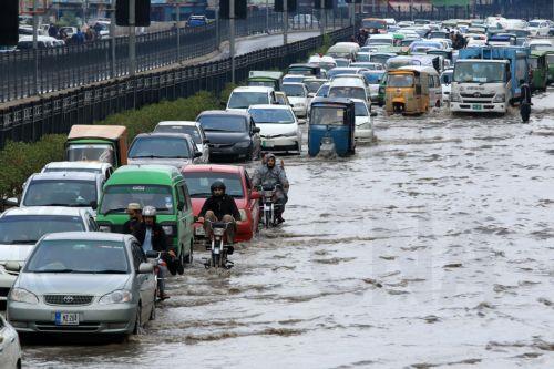 epa11165903 Motorists in a flooded street during a heavy downpour in Peshawar, Pakistan, 19 February 2024. According to the Provincial Disaster Management Authority, at least four people have died and nine have been injured, with numerous buildings damaged as a result of ongoing rains across the province, with more rain expected in the region.  EPA/BILAWAL...