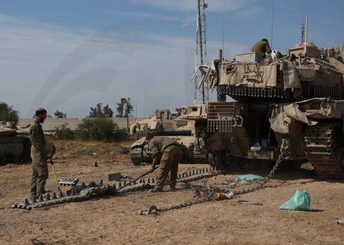epa11265664 Israeli Soldiers from Unit 98 perform maintenance work on their tanks after withdrawing from Khan Yunis in the southern Gaza Strip, at an undisclosed location near the Gaza border, Israel, 08 April 2024. Six months after the 07 October Hamas attacks on Israel, the Israeli army announced on 07 April its partial withdrawal from parts of the...