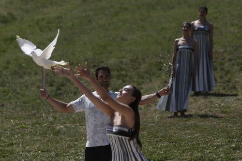 epa11279787 An actress (R), in the role of a priestess, releases a dove during the rehearsal of the Olympic flame lighting ceremony for the Paris 2024 Summer Olympic Games, at the Ancient Olympia site in Peloponnese, southern Greece,15 April 2024. The Lighting ceremony of the Olympic Flame, ahead of the XXXIII Summer Olympic Games 'Paris 2024' which will...