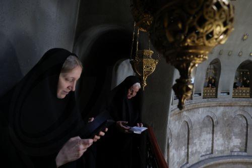 epa11317580 Orthodox Christian worshippers gather at the rooftop above the Tomb of Christ as they wait for the â€˜Holy Fireâ€™ ceremony at the Church of the Holy Sepulchre, in Jerusalem, 04 May 2024. Eastern Orthodox Christians believe that the 'Holy Fire' emanates from within the Tomb of Christ inside the Church of the Holy Sepulcher on the Holy Saturday....