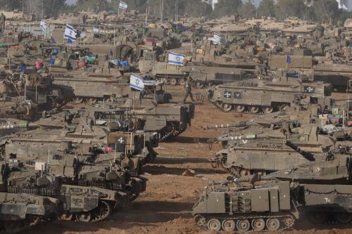 epa11329409 Israeli military vehicles gathered near the border fence with the Gaza Strip, at an undisclosed location in southern Israel, 09 May 2024. On 07 May, Israel said that its troops began an operation targeting Hamas militants and infrastructure within specific areas of eastern Rafah, taking operational control of the Gazan side of the Rafah...
