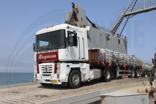 epa11348732 A handout photo made available by the US Central Command (CENTCOM) shows a truck loaded with humanitarian aid from the United Kingdom driving from a US Navy ship onto the Trident Pier, built on the Gaza coast as a way to bring humanitarian aid into the area, 17 May 2024. The temporary pier was built by the United States military as a way to...