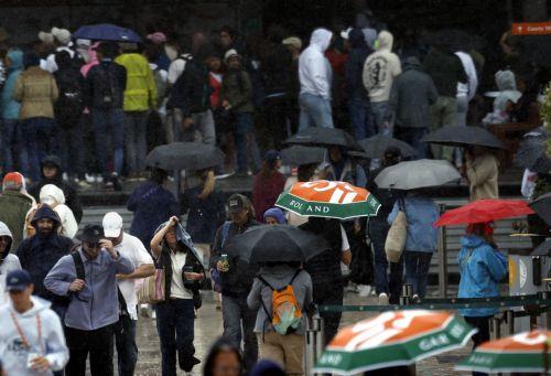 epa11373253 Spectators walk around as rain interrupts play during the French Open Grand Slam tennis tournament at Roland Garros in Paris, France, 27 May 2024.  EPA/YOAN VALAT