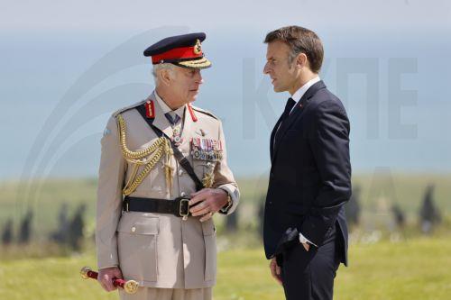 epa11393348 Britain's King Charles III (L) and France's President Emmanuel Macron discuss during the UK Ministry of Defence and the Royal British Legionâ€™s commemorative ceremony marking the 80th anniversary of the World War II 'D-Day' Allied landings in Normandy, at the World War II British Normandy Memorial near the village of Ver-sur-Mer which overlooks...