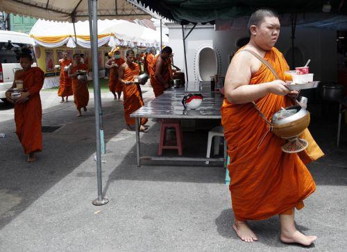 epa11399680 Thai Buddhist monks collect food alms after a health check program at a Buddhist temple in Bangkok, Thailand, 09 June 2024. The Thai Public Health Ministry launched a health check program and healthcare campaign to the estimated 72,000 Buddhist monks across Thailand aimed to raise awareness of good health amid the growing concern of monks...