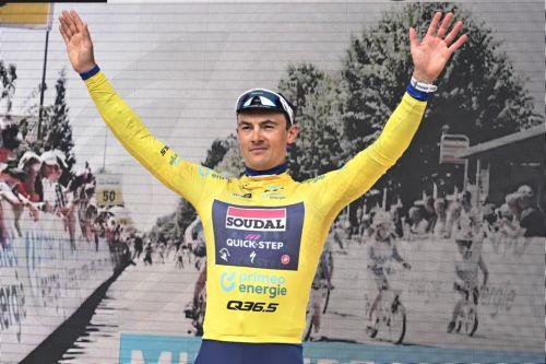 epa11400261 Yves Lampaert from Belgium of Soudal Quick-Step celebrates on the podium in the yellow leader's jersey, after the first stage of the 87th Tour de Suisse cycling race, an individual time trial over 4.8 km with start and finish in Vaduz, Liechtenstein, 09 June 2024.  EPA/WALTER BIERI