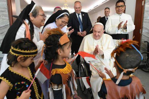 epa11581377 A handout picture provided by the Vatican Media shows Pope Francis (C-R) meeting with a group of refugees, orphaned children, elderly people and homeless people, upon his arrival in Jakarta, Indonesia, 03 September 2024. Pope Francis is on an apostolic visit to the Muslim-majority country from 03 to 06 September and is expected to meet with...
