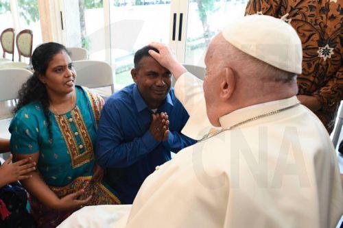 epa11581375 A handout picture provided by the Vatican Media shows Pope Francis (R) meeting with a group of refugees, orphaned children, elderly people and homeless people, upon his arrival in Jakarta, Indonesia, 03 September 2024. Pope Francis is on an apostolic visit to the Muslim-majority country from 03 to 06 September and is expected to meet with...