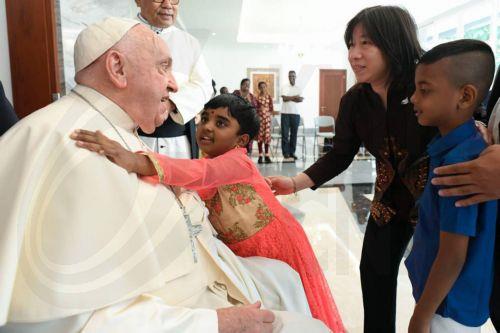 epa11581378 A handout picture provided by the Vatican Media shows Pope Francis (L) meeting with a group of refugees, orphaned children, elderly people and homeless people, upon his arrival in Jakarta, Indonesia, 03 September 2024. Pope Francis is on an apostolic visit to the Muslim-majority country from 03 to 06 September and is expected to meet with...