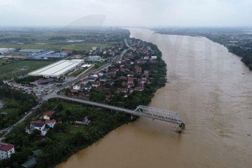 epa11594351 A handout photo made available by Vietnam News Agency shows an aerial view of the partially collapsed Phong Chau bridge into Red River, in Phu Tho province, northern Vietnam, 09 September 2024. According to state media, three people have been rescued and at least thirteen are missing following the collapse of the bridge into Red River on 09...