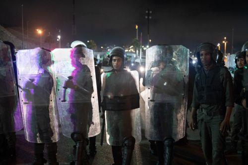 epa11608880 Moroccan public security forces deploy near a customs checkpoint along the land border with the Spanish enclave of Ceuta, in Fnideq, northern Morocco, 16 September 2024. Hundreds of migrants on 15 September stormed a barbed wire fence to cross the land border from Fnideq to Ceuta, following a call on social media for a mass migration attempt,...