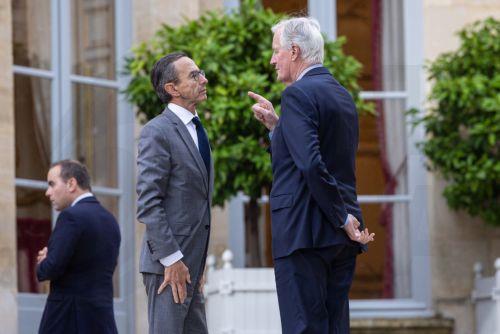 epa11628944 French Prime Minister Michel Barnier (C-R) and Interior Minister Bruno Retailleau (C-L) speak after posing for a group picture with members of the new cabinet after a government seminar meeting held at Matignon Hotel in Paris, France, 27 September 2024. The new government of France's new Prime Minister Barnier was announced on 21 September. ...