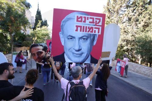 epa11633269 A man holds a sign reding 'cabinet of death' during a protest where families of Israeli hostages held by Hamas in Gaza trying to reach Prime Minister Benjamin Netanyahuâ€™s residence, calling for a ceasefire and for the release of Israeli hostages, in Jerusalem, 30 September 2024. According to the Israeli military, at least 100 Israeli hostages...