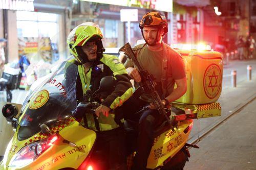 epa11636342 Israeli medical services and security personnel on a motorbike at the site of a shooting incident in Tel Aviv, Israel, 01 October 2024. According to Israeli police, at least eight people were killed and nine others wounded in a shooting incident on Sderot Yerushalim in Tel Aviv. Two gunmen have been 'neutralized' on site, police said.  EPA/ABIR...