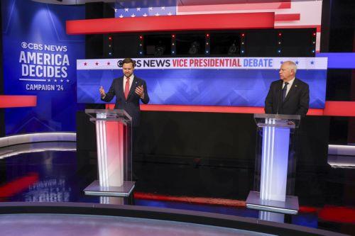 epa11636940 Republican vice presidential nominee JD Vance (L), and Minnesota Governor and Democratic vice presidential nominee Tim Walz (R) during the Vice Presidential debate at the CBS Broadcast Center in New York, New York, USA, 01 October 2024.  EPA/SARAH YENESEL