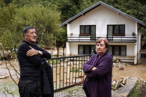 epa11641738 Local residents stand in front of a house damaged by the flash floods in the village of Trosnjik near Fojnica, Bosnia and Herzegovina, 04 October 2024. Central and southern parts of Bosnia and Herzegovina were hit by a severe rainstorm overnight, which caused widespread flooding, closing roads, cutting electricity, and disrupting telecom...