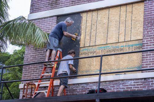 epa11650028 Fort Myers residents place plywood over second floor windows as they prepare for Hurricane Milton in Fort Myers, Florida, USA, 08 October 2024. According to the National Hurricane Center's Live Hurricane Tracker, Hurricane Milton is set to make landfall on the west coast of Florida on  the evening of 09 October. After rapidly intensifying into a...