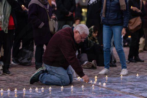 epa11654331 Community members gather for a Free Palestine Melbourne vigil to remember victims of the Gaza attacks at Federation Square in Melbourne, Australia, 11 October 2024. A Free Palestine Melbourne vigil is taking place at Federation Square, where community members are gathering to remember victims of Israeli attacks in Gaza.  EPA/DIEGO FEDELE...