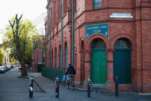 epa11658009 A person cycles past the Salford Lads Club in Salford, Britain, 14 October 2024. The club, which was opened in 1903 to provide recreation and sport for boys, is threatened with closure due to the rising costs of delivering youth programmes and maintaining its grade II listed building. The club gained international fame when used as the backdrop...