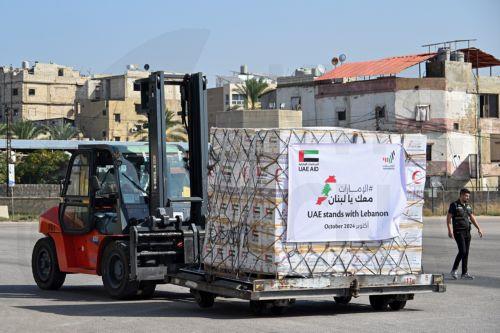 epa11658027 Workers unload relief supplies provided by the United Arab Emirates at Beirut airport, in Beirut, Lebanon, 14 October 2024. The United Arab Emirates launched the nationwide campaign 'UAE Stands with Lebanon' running from 13 to 21 October to gather supplies for the people of Lebanon. According to the Lebanese Ministry of Health, more than 2,300...
