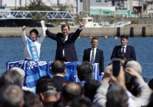 epa11659872 Japanese Prime Minister Shigeru Ishiba (2-L) raises his arms with a ruling Liberal Democratic Party (LDP) candidate during an election campaign rally at Onahama Fish Market in Iwaki, Fukushima prefecture, northeastern Japan, 15 October 2024. Prime Minister Ishiba made his first speech at the kick-off of the official campaigning for the 27...