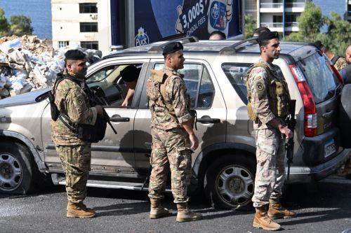 epaselect epa11668088 Lebanese soldiers inspect the site of a drone attack in Sahel Alma, north Beirut, Lebanon, 19 October 2024. According to Lebanon's National News Agency (NNA), two people were killed after an Israeli drone targeted their car on the Jounieh highway before pursuing them in the forest adjacent to the highway. Two others were injured in the...