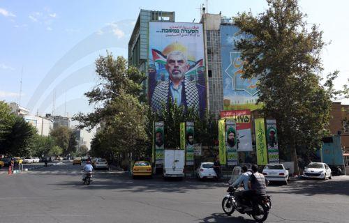 epa11668166 Iranians drive past a billboard of Hamas' slain leader Yahya Sinwar at the Palestine square in Tehran, Iran, 19 October 2024. Iranian supreme leader Ayatollah Ali Khamenei on 19 October issued a message over the death of Yahya Sinwar, stating that 'the resistance did not stop after the death of its leaders, and it will not stop'. The Israeli...