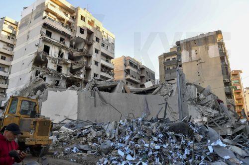 epa11672395 People inspect the site of an Israeli airstrike that targeted a branch of the Al-Qard Al-Hassan finance group in Al-Shiyah, Beirut, Lebanon, 21 October 2024. The Israeli military said the air forces conducted late on 20 October a series of targeted strikes against dozens of facilities and sites used by Al-Qard al-Hassan Association, an...