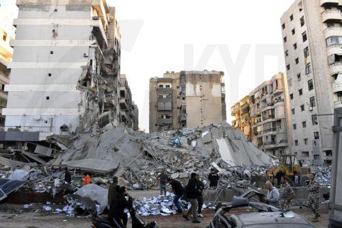 epaselect epa11672390 People inspect the site of an Israeli airstrike that targeted a branch of the Al-Qard Al-Hassan finance group in Al-Shiyah, Beirut, Lebanon, 21 October 2024. The Israeli military said the air forces conducted late on 20 October a series of targeted strikes against dozens of facilities and sites used by Al-Qard al-Hassan Association, an...