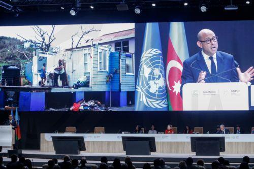 epa11714176 United Nations Framework Convention on Climate Change (UNFCCC) Executive Secretary Simon Stiell (L) appears on a screen (R) as he speaks during the opening ceremony of the UN Climate Change Conference (COP29) in Baku, Azerbaijan, 11 November 2024. The Azerbaijani capital of Baku hosts the 2024 United Nations Climate Change Conference (COP29)...
