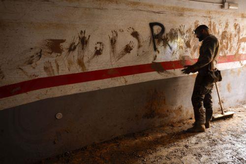 epaselect epa11716245 Spanish soldiers clean a garage in the flood-hit municipality of Paiporta, Valencia province, Spain, 12 November 2024. The floods in Valencia and neighboring provinces have caused at least 222 fatalities, as efforts continue to search for missing people, provide supplies, and care for the victims after the DANA (high-altitude isolated...