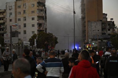 epa11721253 People watch as smoke rises following an Israeli airstrike in the Al-Chiyah area in southern Beirut, Lebanon, 14 November 2024. According to the Lebanese Ministry of Health, around 3,365 people have been killed and over 14,344 others have been injured in Lebanon since the escalation in hostilities between Israel and Hezbollah.  EPA/WAEL HAMZEH