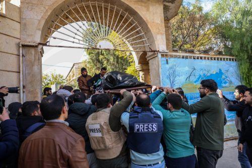 epa11756387 People carry the body of Syrian photojournalist Anas al-Kharboutli, who was killed in an airstrike, during his funeral procession in Idlib, Syria, 04 December 2024. Al-Kharboutli was killed on 04 December in an airstrike on Murk city, Hama countryside, while covering the ongoing fighting between opposition and government forces, according to the...