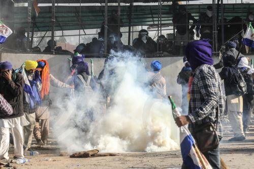 epa11760116 Indian farmers react amidst tear gas fired by the police to prevent them moving towards Delhi during a 'Delhi Chalo' peaceful protest march at Shambhu Haryana-Punjab inter-state border, in India, 06 December 2024. Around 101 farmers from several associations gathered to begin a march on foot from Shambhu Haryana-Punjab border point to Delhi on...