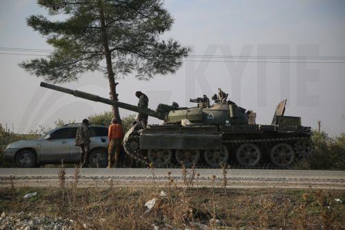 epa11760247 Opposition fighters stand on a tank of the Syrian government after they entered the city of Hama, Syria, 06 December 2024. Syrian opposition forces, led by the Islamist militant group Hayat Tahrir al-Sham (HTS), launched an offensive on 27 November, triggering counterattacks by the Syrian regime forces as well as Russian and Syrian airstrikes on...