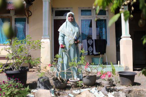 epa11790737 Marlina, a survivor of the 2004 Asian tsunami, stands on the foundation of her original house, which was rebuilt during the rehabilitation and reconstruction efforts in Mon Ikeun village, Lhok Nga, Aceh Besar, Indonesia, 08 December 2024 (issued 23 December 2024). Two decades after the Asia tsunami disaster, Marlina continues to rebuild her life...