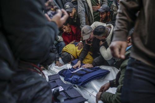 epa11793720 People mourn near the covered bodies of Palestinian journalists killed in an overnight Israeli airstrike in Al Nuseirat refugee camp, at Al Aqsa Martyrs Hospital in Deir Al Balah, central Gaza Strip, 26 December 2024. According to the Government Media Office (GMO) in Gaza, five journalists from the 'Al-Quds Today' TV satellite channel were...