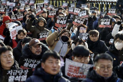 epa11803246 Members of the Korean Confederation of Trade Unions (KCTU) shout slogans and hold placards reading 'Arrest Yoon Suk Yeol immediately' during a rally against impeached president Yoon near the presidential residence in Seoul, South Korea, 03 January 2025. A Seoul court on 31 December 2024 issued an arrest and search warrant to detain impeached...