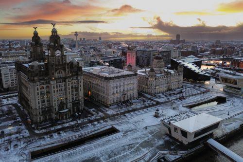 epa11810779 An aerial photograph taken by drone shows snow on the ground surrounding the Royal Liver Building, Cunard Building and Port of Liverpool buildings in Liverpool, Britain, 07 January 2025. The Met Office has issued further yellow warnings for snow and ice across Northern Ireland and the west coast of Britain after heavy snowfall and rain caused...