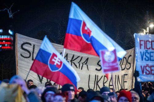 epa11817193 People wave flags and hold placards during a demonstration against the Slovak prime minister, in front of the Government Office building, in Bratislava, Slovakia, 10 January 2025. The protests, titled 'Slovakia is Europe- Enough of Russia!', were sparked by Prime Minister Robert Fico's meeting with Russian President Vladimir Putin in Moscow in...