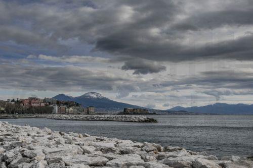 epa11821953 The snow-capped Mount Vesuvius is seen in the background from the Naples waterfront, in Naples, southern Italy, 13 January 2025.  EPA/CIRO FUSCO