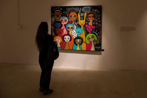 epa11824960 A woman looks at an artwork in the exhibition 'Te amo, Mon Laferte Visual' by Chilean artist Mon Laferte at the Valparaiso Cultural Park, in Valparaiso, Chile, 14 January 2025. Chilean singer and artist Mon Laferte was named cultural ambassador of Valparaiso.  EPA/Cristobal Basaure