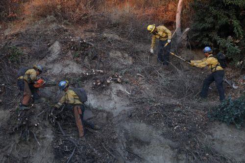 epa11825216 CalFire crews work to clear off debris along the Pacific Coast Highway near the Pacific Palisades and Santa Monica in Los Angeles, California, USA, 14 January 2025. Much of Southern California is under an elevated fire risk, as the Santa Ana winds have returned and are predicted to affect the area until Wednesday evening according to the...