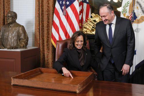 epa11829435 US Vice President Kamala Harris points to her signature after taking part in a ceremonial desk signing at the Eisenhower Executive Office Building in Washington, DC, USA, 16 January 2025. Joined by the Second Gentleman Doug Emhoff (R), Vice President Kamala Harris took part in a ceremony that has been observed since the Ford administration but...