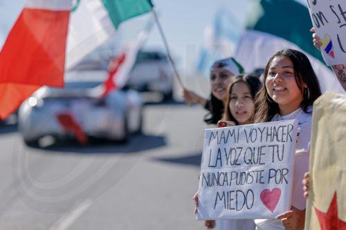 epa11869355 A sign reads 'Mommy, I'm going to be the voice that you never could be because of fear' as people demonstrate along Buford Highway during a large protest against the Trump administration's immigration and deportation sweeps against undocumented aliens in Atlanta, Georgia, USA, 01 February 2025. The area of the protest has a high migrant...