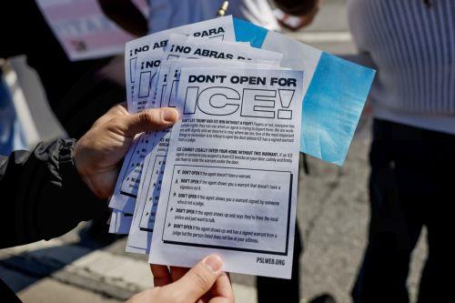 epaselect epa11869295 An activist hands out flyers in English and Spanish on how to respond to a raid by US Immigration and Customs Enforcement (ICE) raids during a protest against the Trump administration's immigration and deportation sweeps against undocumented aliens in Atlanta, Georgia, USA, 01 February 2025. The area of the protest has a high migrant...